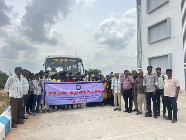 Students and staff with the college banner